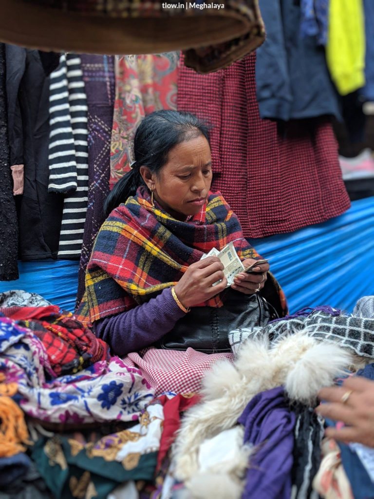 Lady counting money in Shillong