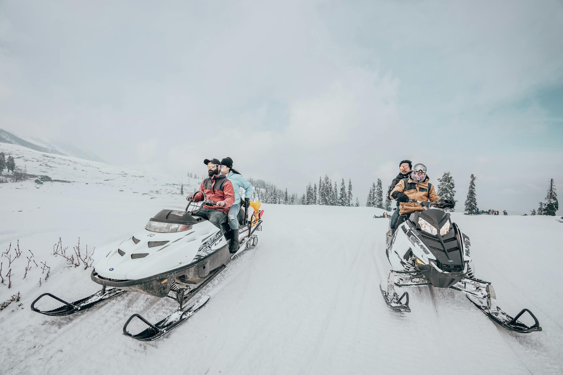 people riding a snowmobile