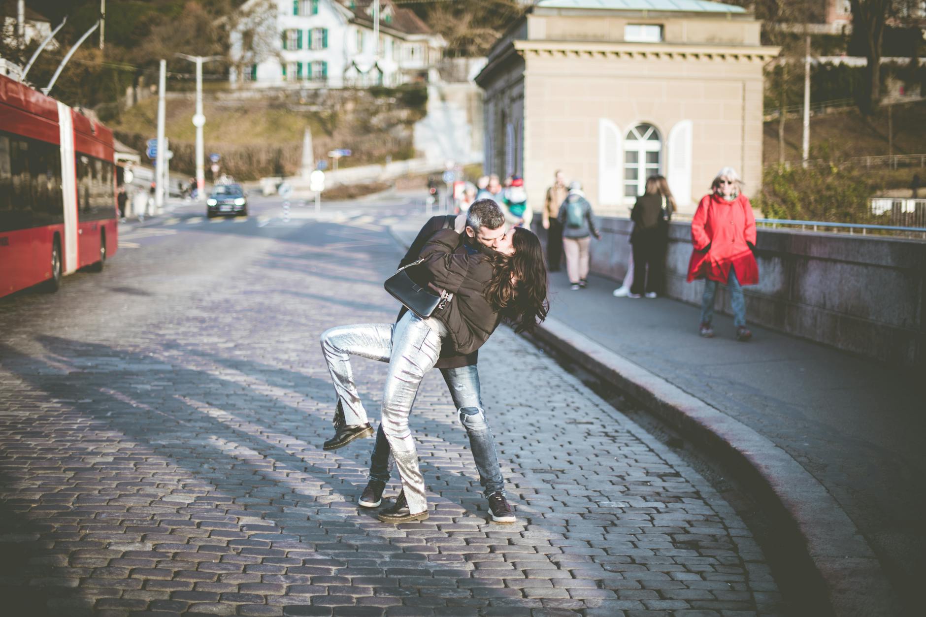 couple kissing on bridge in town