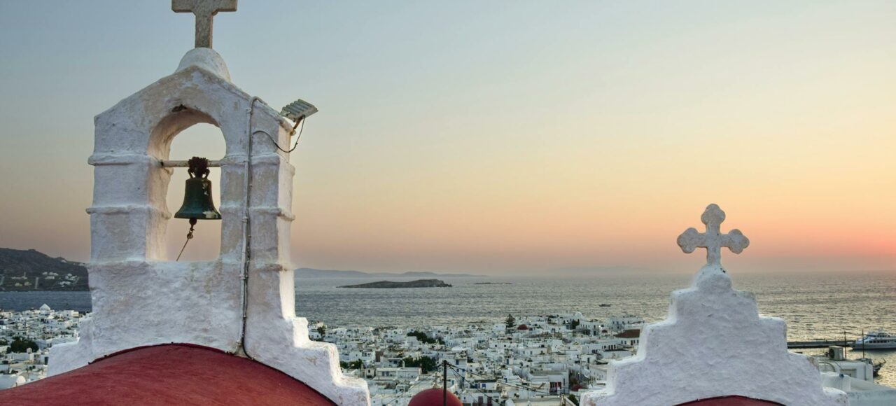 towers of church on mykonos in greece at sunrise