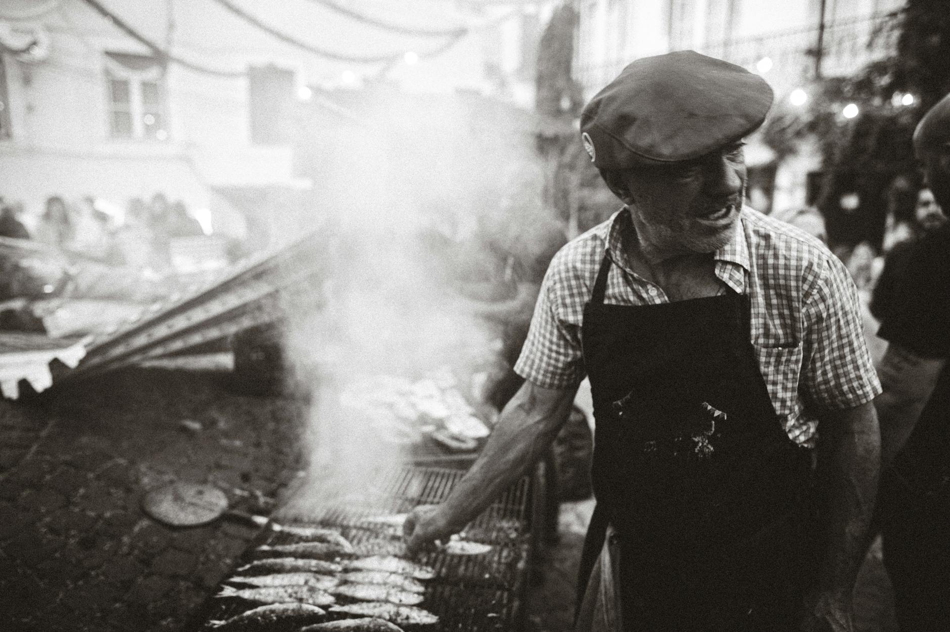 vendor by barbecue with fish