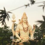 lord shiva statue surrounded by trees