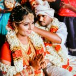 groom sitting by bride in traditional dress at wedding ceremony