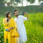 couple taking a picture on a field in india