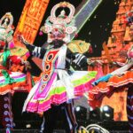 three people dancing at a festival in tamil nadu