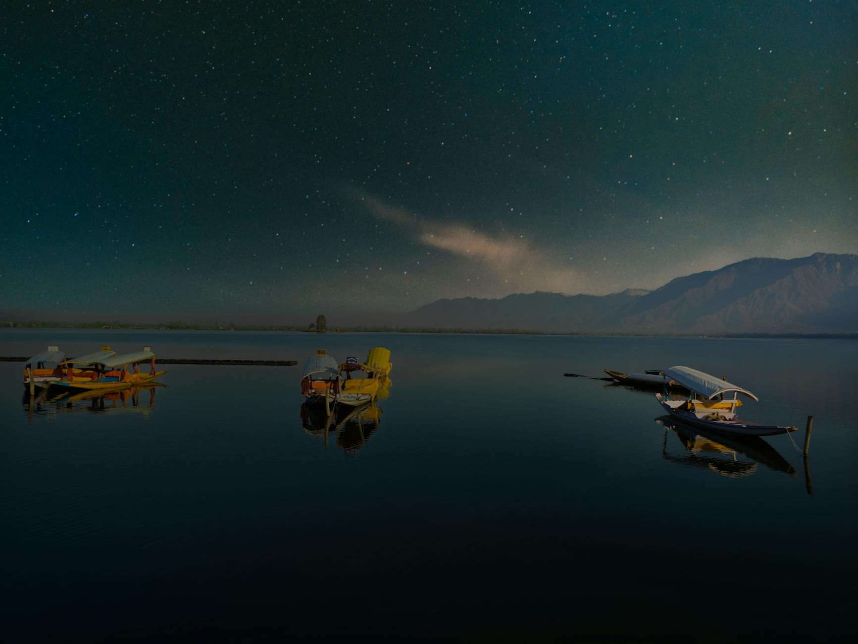 view of boats on the dal lake at night srinagar jammu and kashmir india
